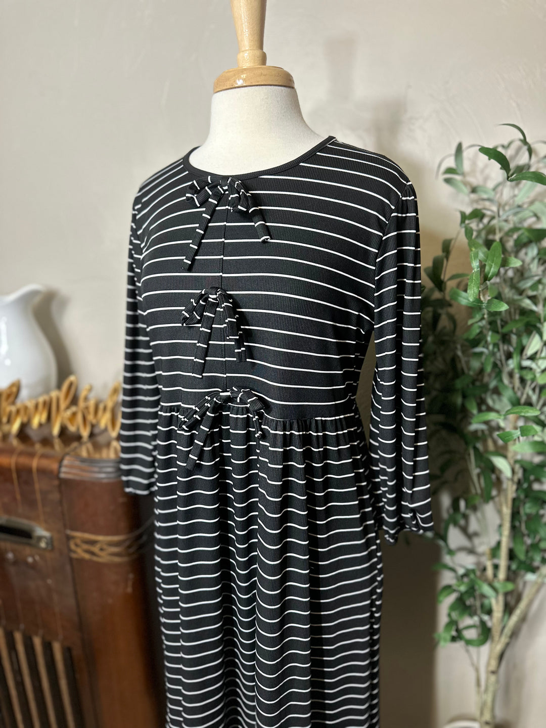 Ellie Triple Bow Striped Dress in black, 3/4 sleeves, angled front view
