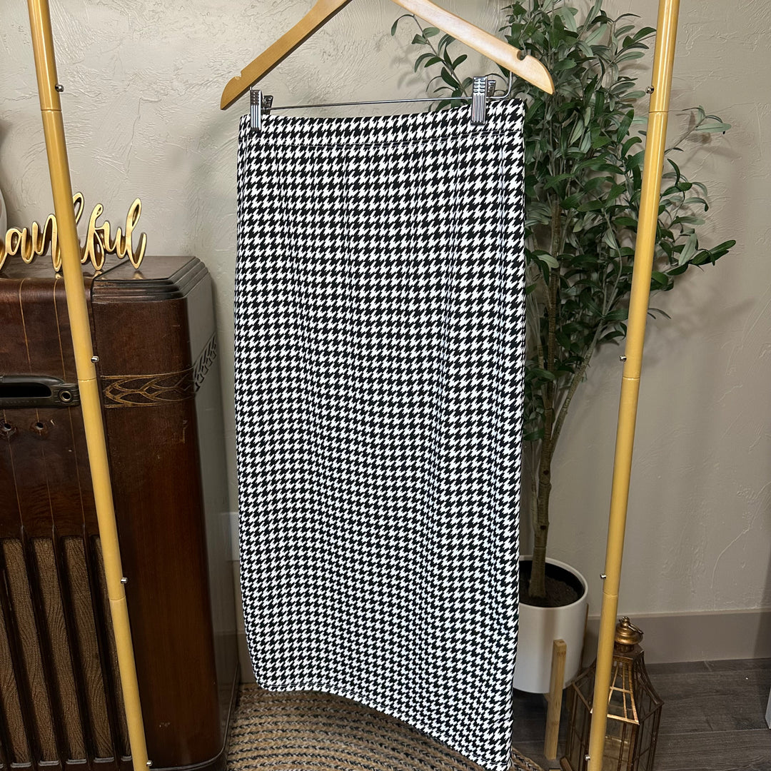 Juliette Pull-On Midi Skirt in houndstooth, straight midi length, angled view on hanger