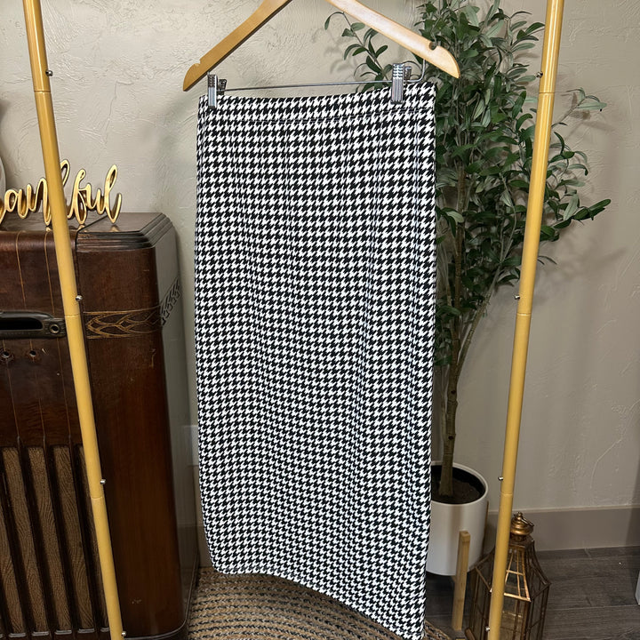 Juliette Pull-On Midi Skirt in houndstooth, straight midi length, angled view on hanger