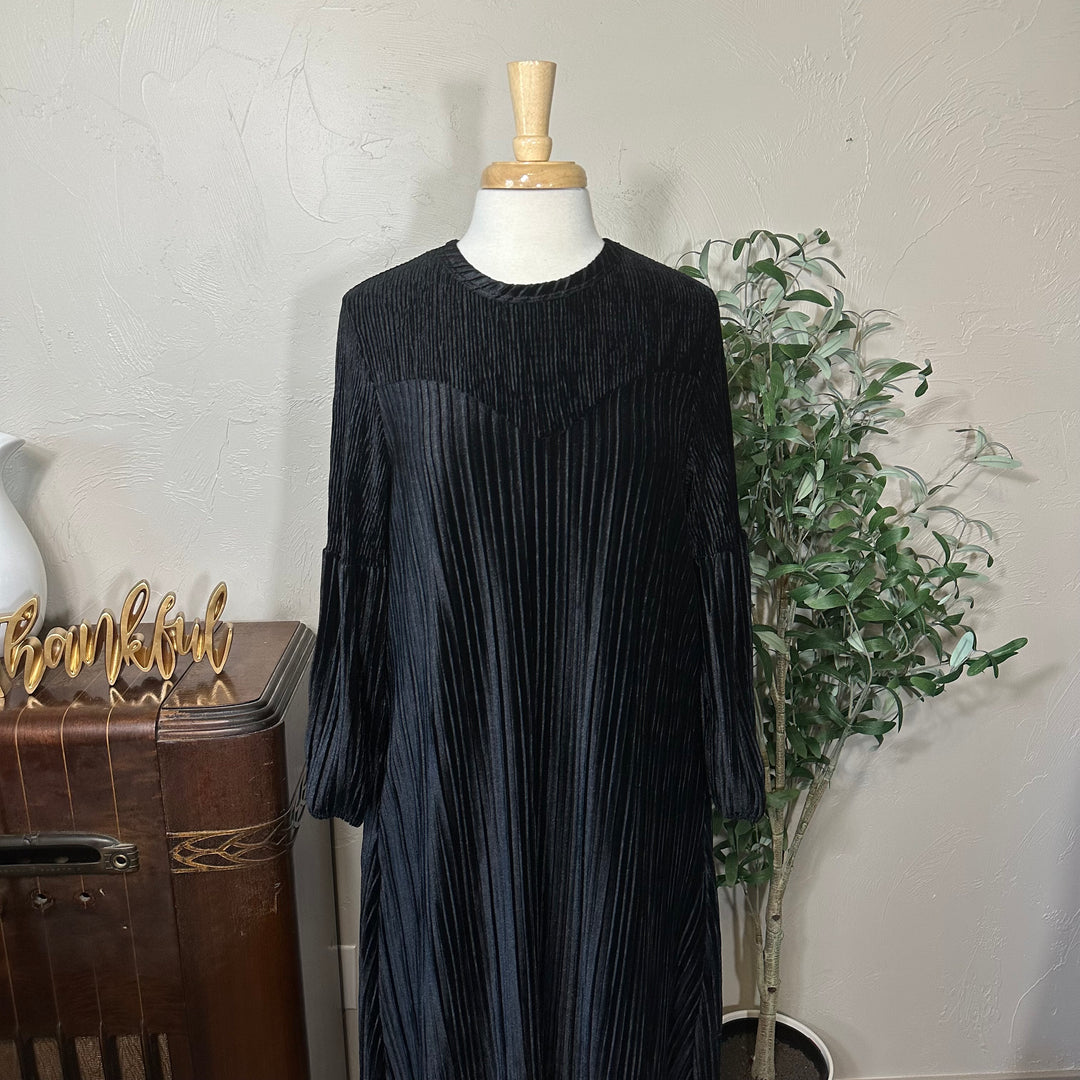 Evelyn Pleated Velvet Midi Dress in black, round neckline and curved yoke, front close-up