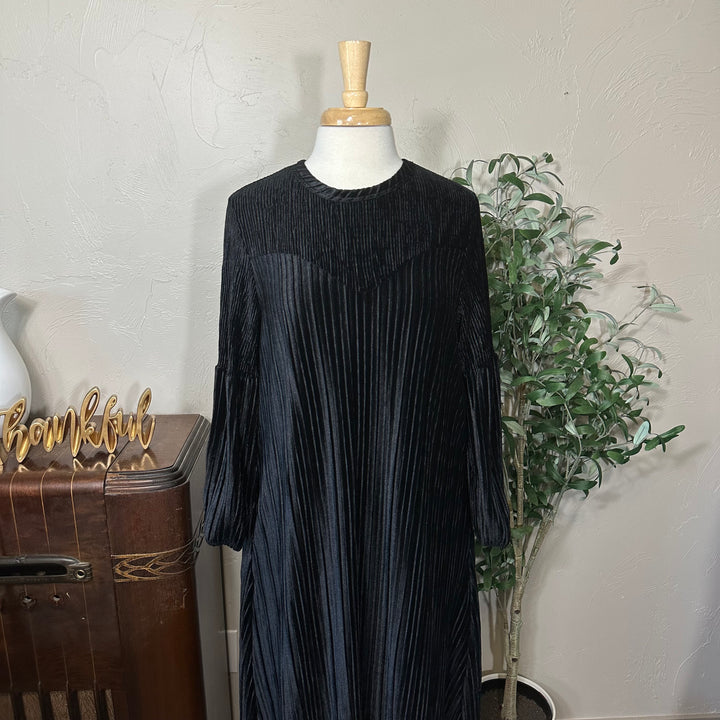 Evelyn Pleated Velvet Midi Dress in black, round neckline and curved yoke, front close-up