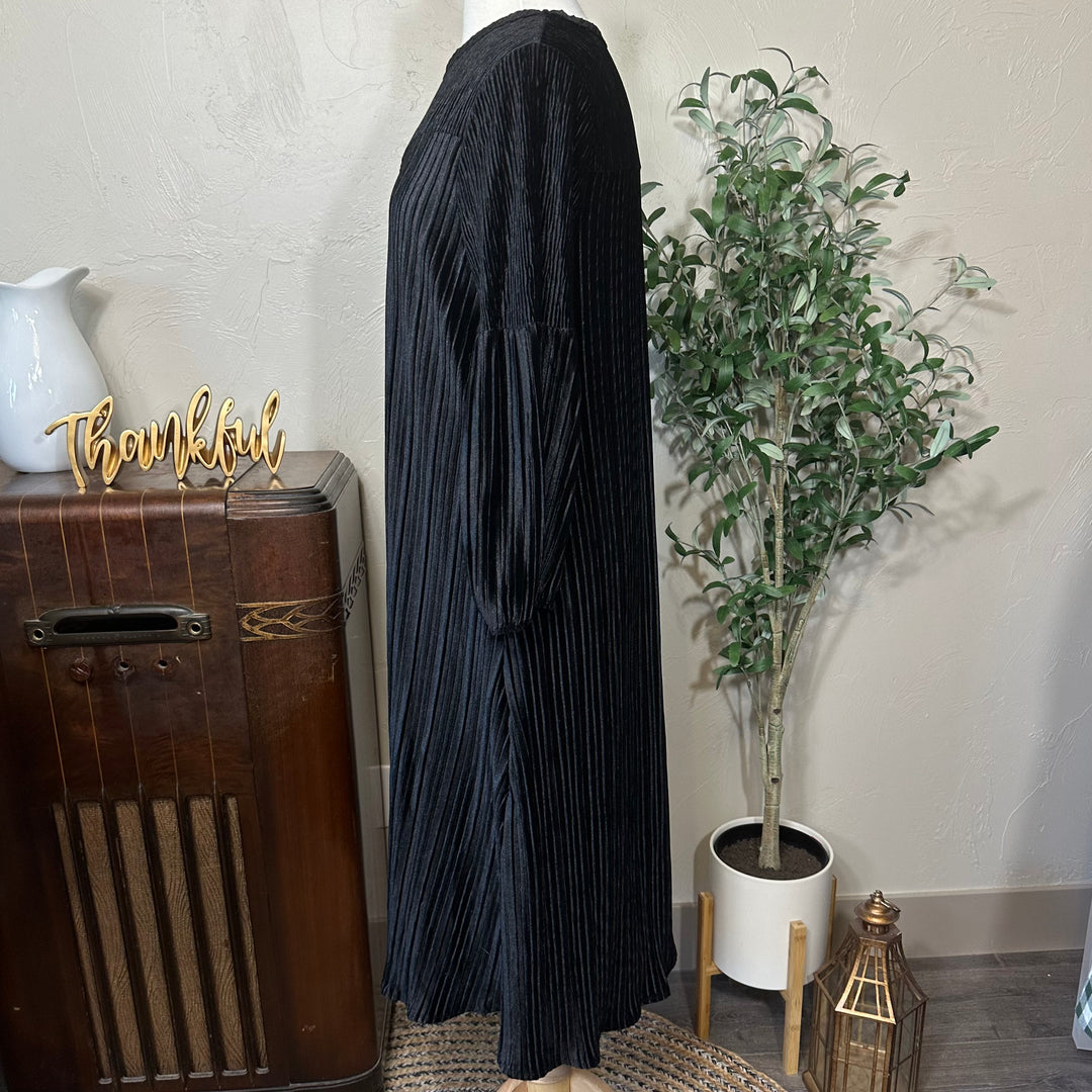Evelyn Pleated Velvet Midi Dress in black, gathered long sleeve, side view