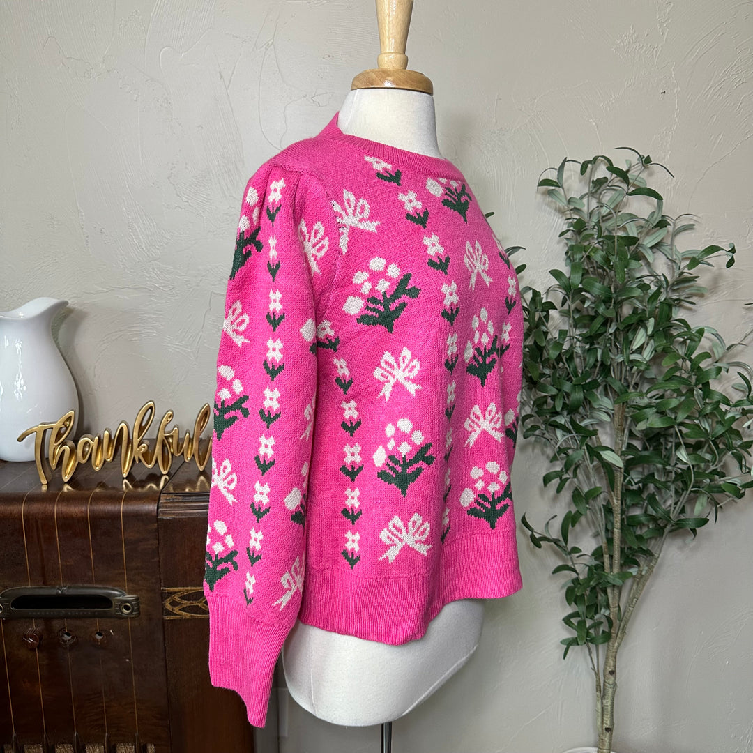 Rosie Bow and Flower Pullover Sweater in pink, gathered shoulder, three-quarter side view