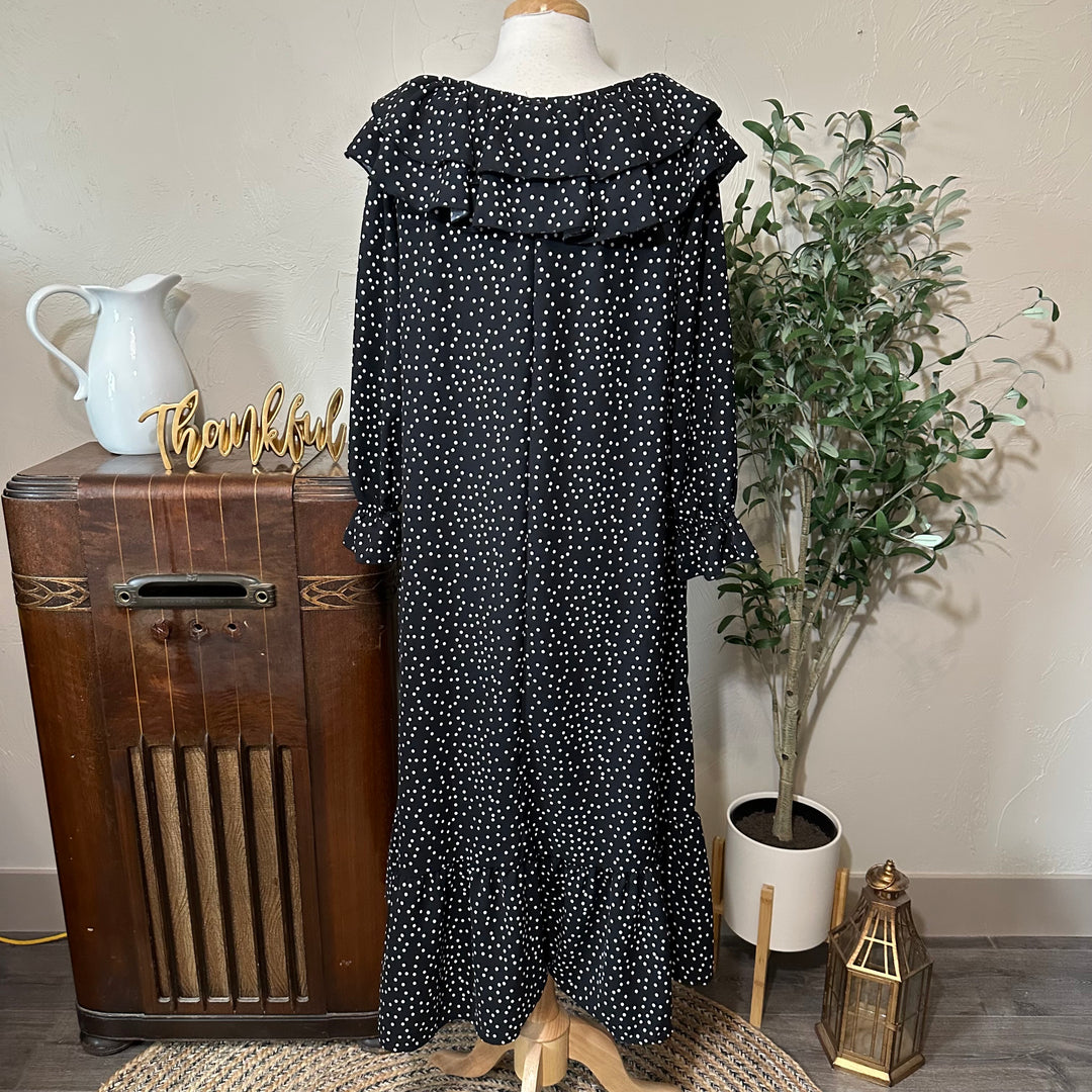 Back view showing the ruffle collar across the back and the long sleeves