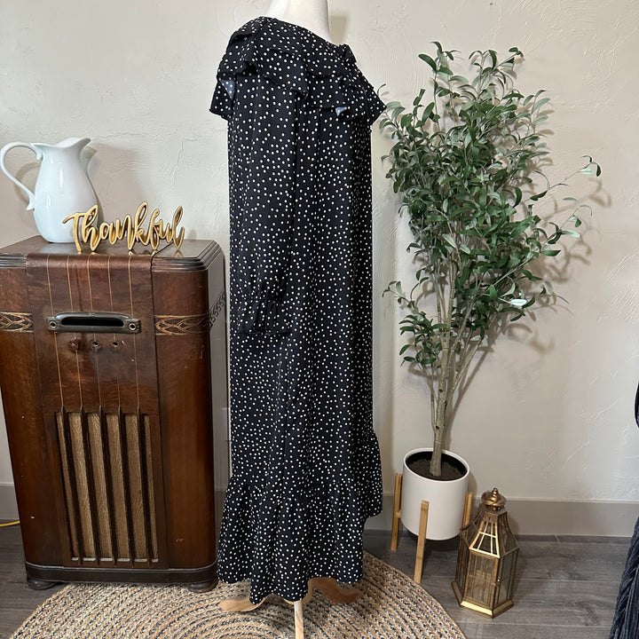 Side view of the full-length polka dot dress with ruffle hem