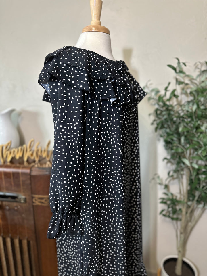 Angled view of the ruffle collar and elastic ruffled cuff on the long sleeve