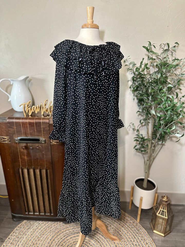 Front view of the black and white polka dot dress showing the ruffle collar and ruffled cuffs