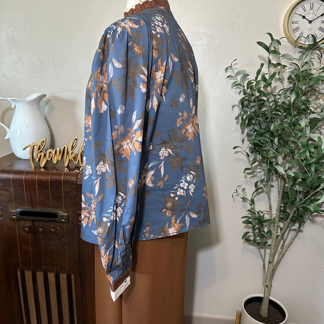 Side view showing the sleeve gathered at the shoulder and the floral print