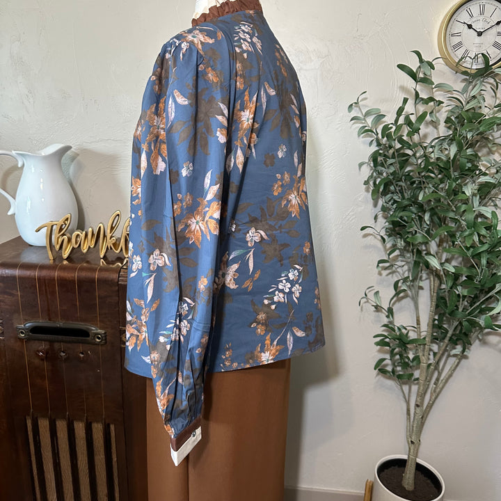 Side view showing the sleeve gathered at the shoulder and the floral print