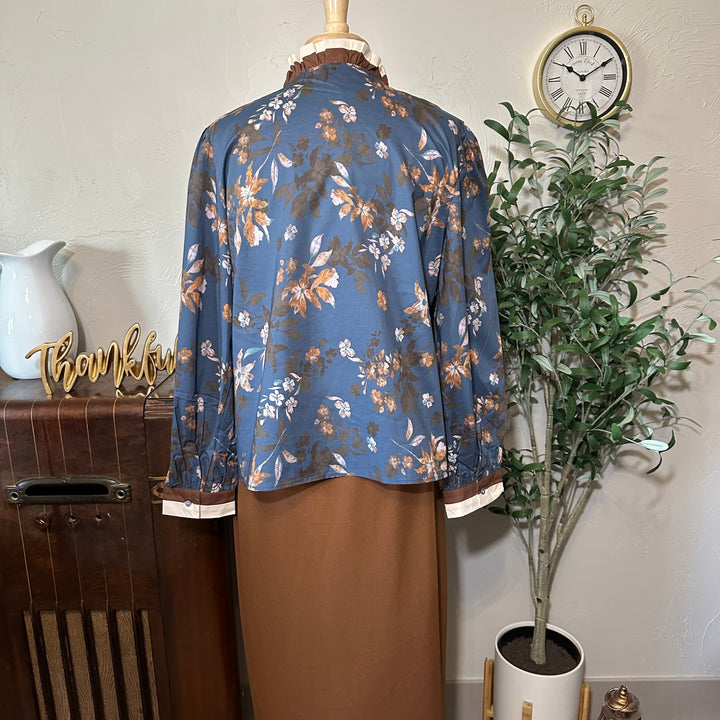 Back view of the floral blouse styled with a brown midi skirt