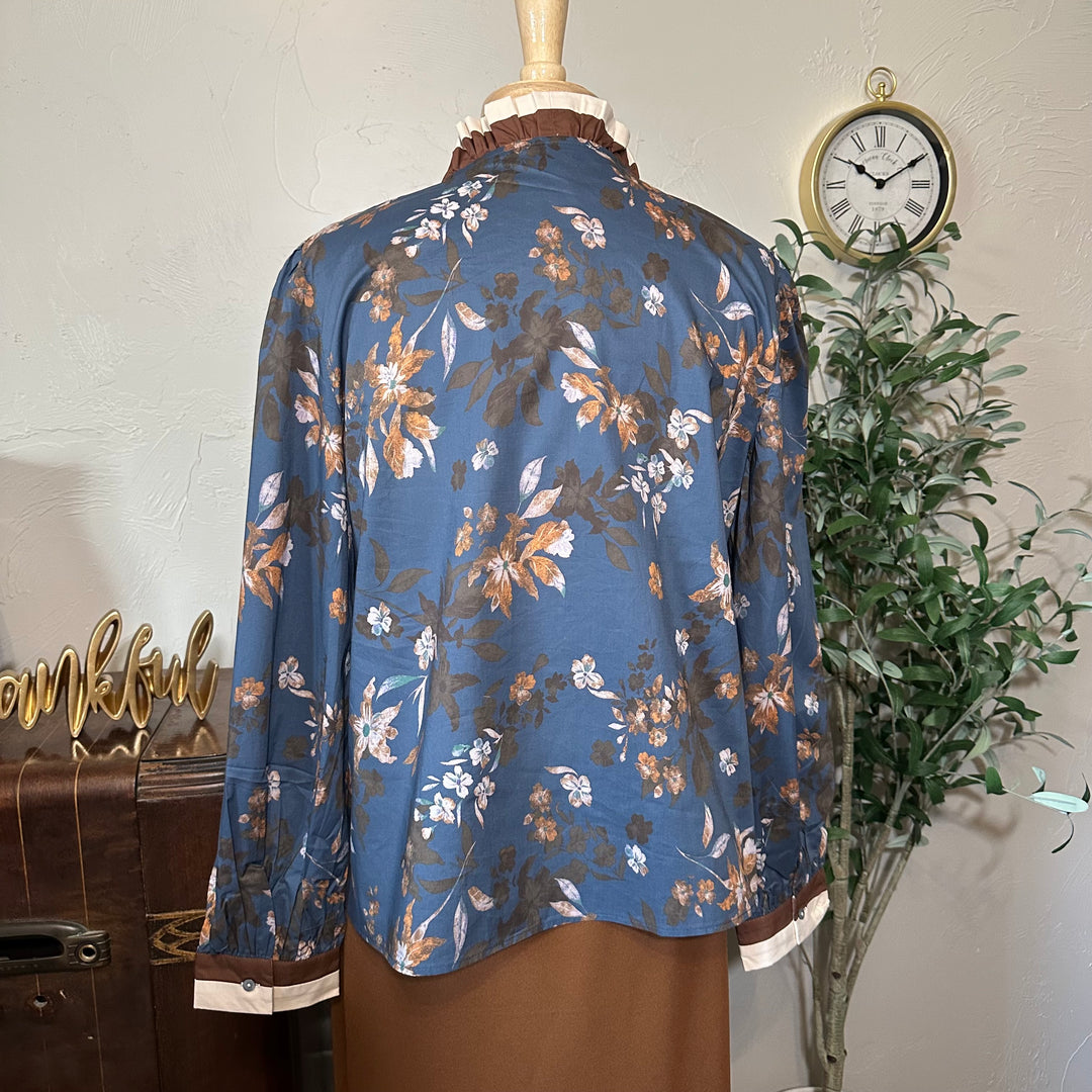 Back view showing the ruffle collar and floral print across the back
