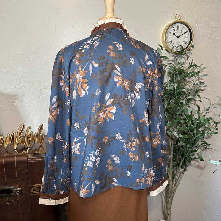 Back view showing the ruffle collar and floral print across the back
